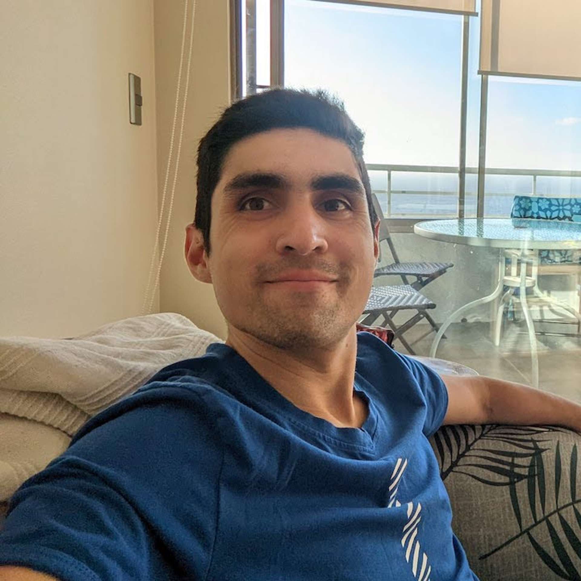 A picture of the   9   <h1>Carlos Molina</h1>
 . author, Carlos Molina, resting in a couch